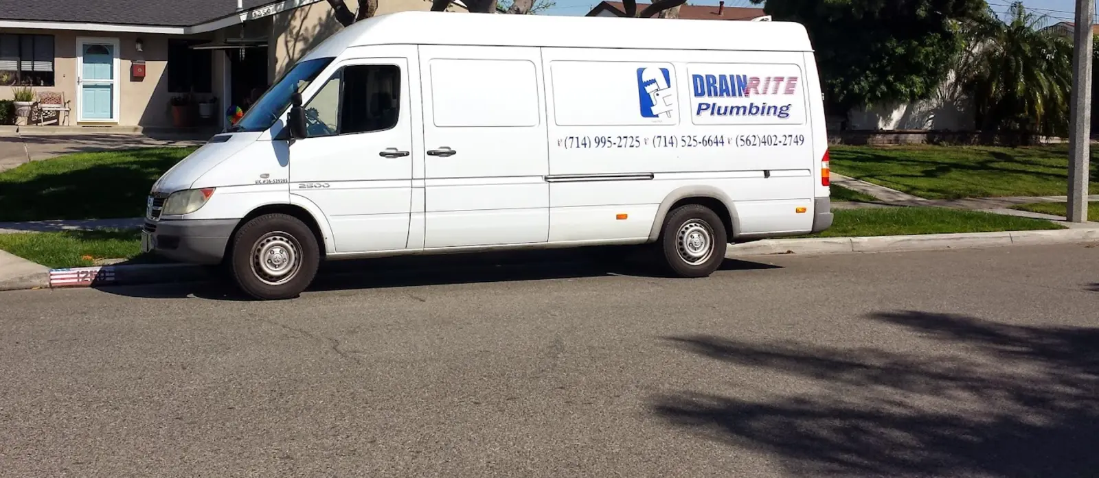 Drain Rite Plumbing service van in a residential neighborhood